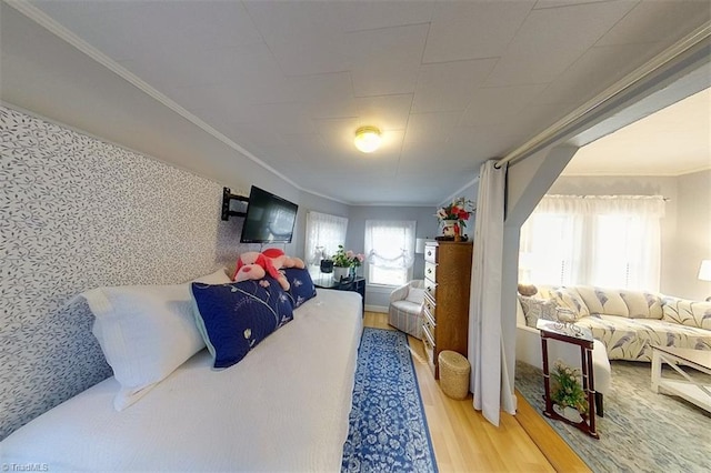 bedroom featuring hardwood / wood-style flooring and crown molding