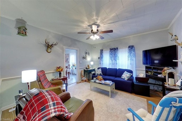 living room featuring wood-type flooring, ceiling fan, and crown molding