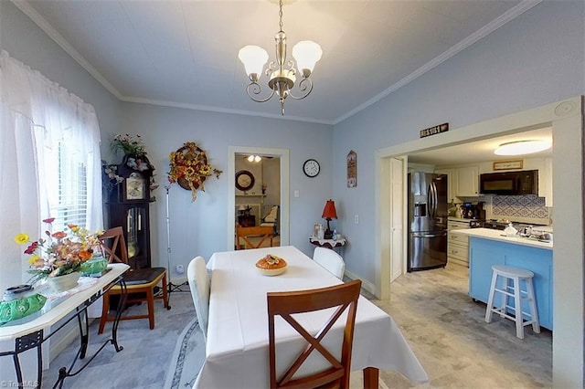 dining area featuring a chandelier and crown molding