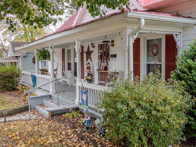 view of exterior entry featuring covered porch