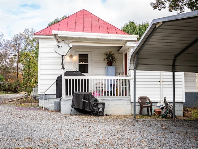 back of property with covered porch