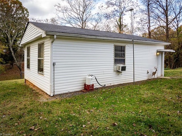 view of side of property with a lawn and cooling unit