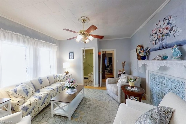 living room featuring light hardwood / wood-style floors, ceiling fan, and crown molding