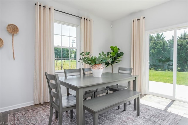 dining area featuring baseboards and wood finished floors