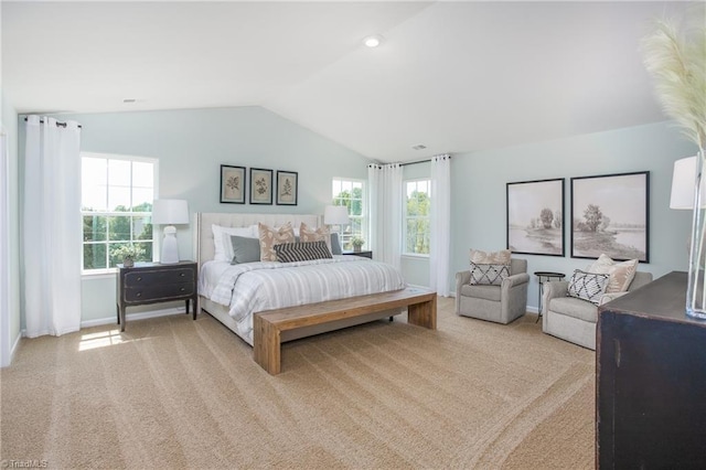 bedroom featuring baseboards, light colored carpet, and lofted ceiling