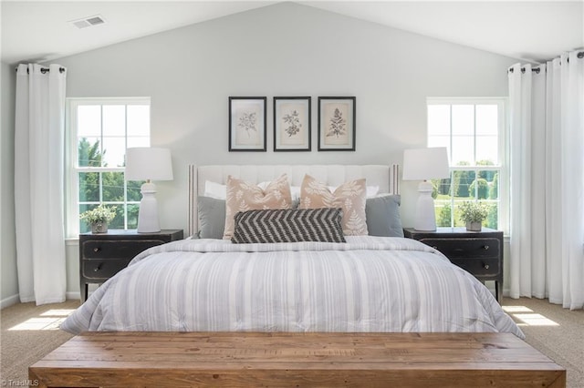 bedroom with visible vents, carpet, vaulted ceiling, and multiple windows