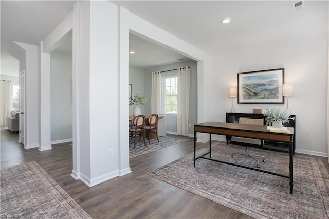 office space with visible vents, baseboards, and wood finished floors
