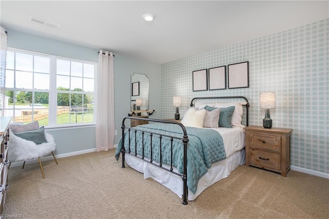 bedroom featuring baseboards, carpet, visible vents, and wallpapered walls