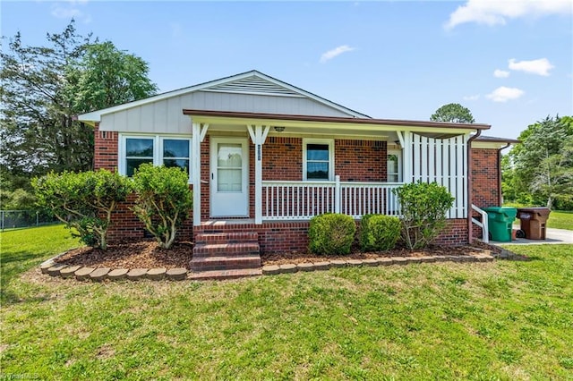 121 Jacklyn Ct, High Point, NC 27265 - view of front of home with a porch, brick siding, and board and batten siding