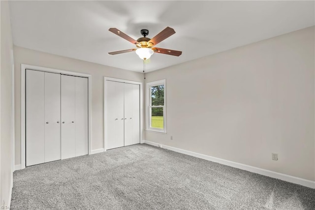 121 Jacklyn Ct, High Point, NC 27265 - unfurnished bedroom featuring two closets, carpet flooring, baseboards, and a ceiling fan