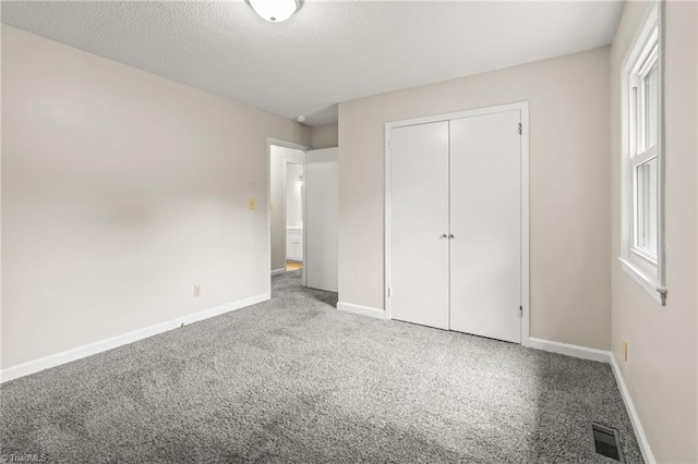 121 Jacklyn Ct, High Point, NC 27265 - unfurnished bedroom featuring carpet, baseboards, a closet, and a textured ceiling