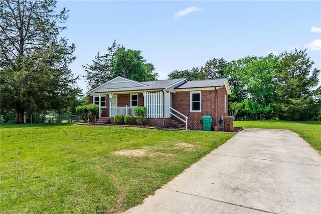 121 Jacklyn Ct, High Point, NC 27265 - view of front of property featuring brick siding, covered porch, a front yard, and concrete driveway