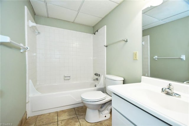 full bath featuring toilet, a drop ceiling, shower / bathtub combination, tile patterned flooring, and vanity