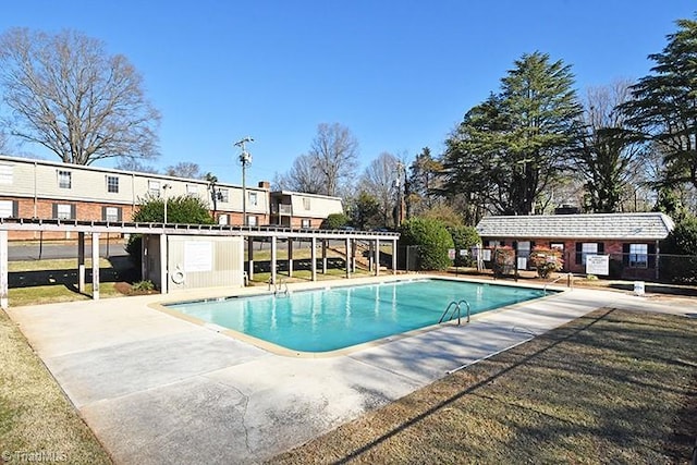 community pool featuring a patio and fence