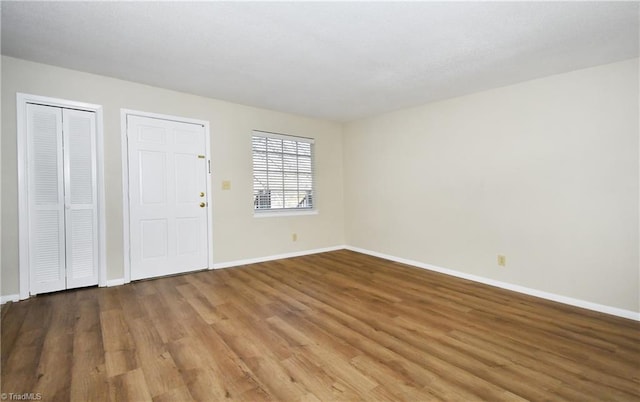 interior space featuring baseboards and wood finished floors