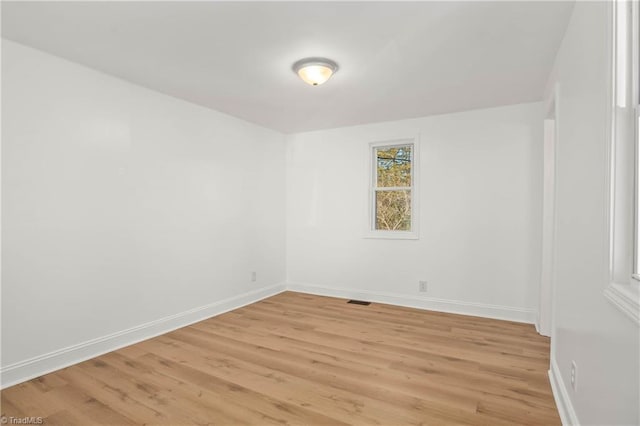 unfurnished room with light hardwood / wood-style floors