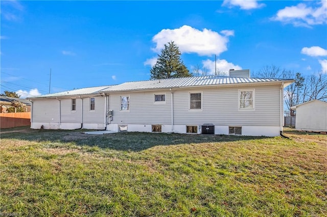 rear view of house with a lawn and central air condition unit