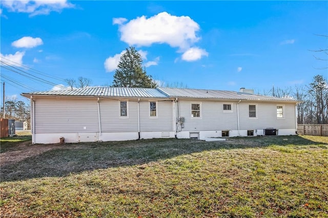 rear view of house with a lawn and central AC unit