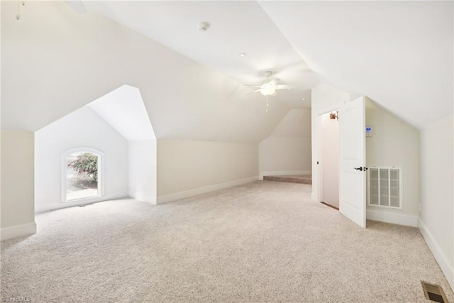 bonus room featuring lofted ceiling, ceiling fan, and light carpet