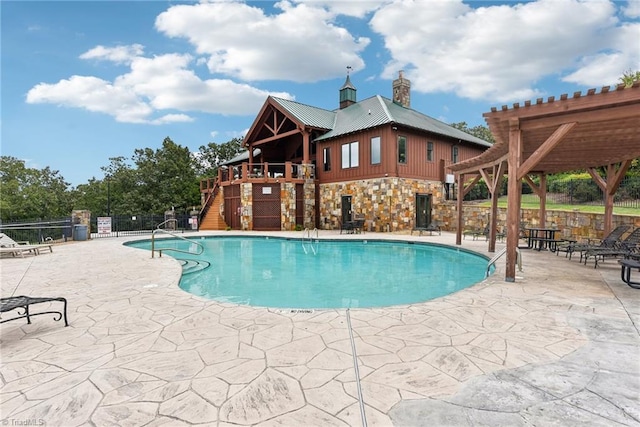 view of swimming pool with a pergola and a patio