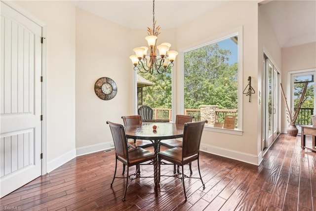 dining room featuring a wealth of natural light, dark hardwood / wood-style floors, and a chandelier