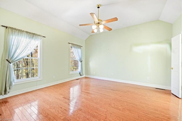 empty room featuring light hardwood / wood-style flooring, ceiling fan, and lofted ceiling