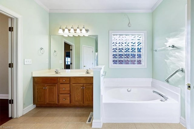 bathroom with tile patterned flooring, crown molding, a washtub, and vanity