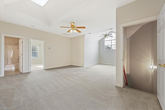 carpeted spare room with vaulted ceiling and ceiling fan