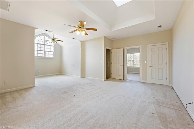 carpeted spare room featuring a wealth of natural light, lofted ceiling, and ceiling fan