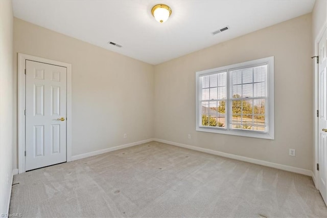 spare room with light colored carpet