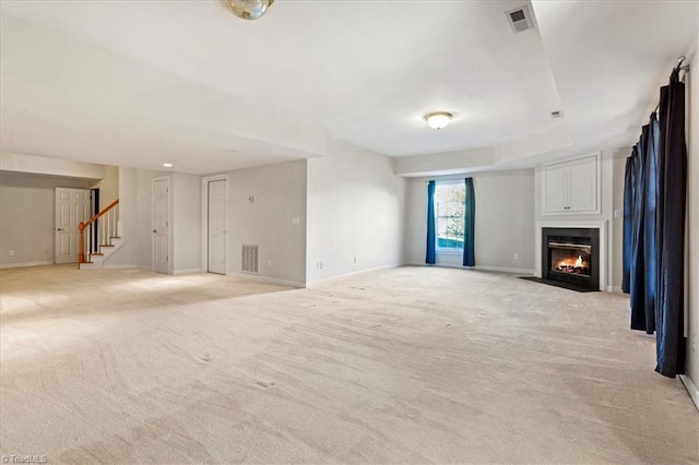 unfurnished living room featuring light colored carpet