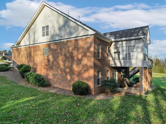 view of property exterior featuring a lawn and a patio