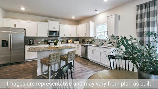 kitchen featuring white cabinets, light stone countertops, and stainless steel appliances