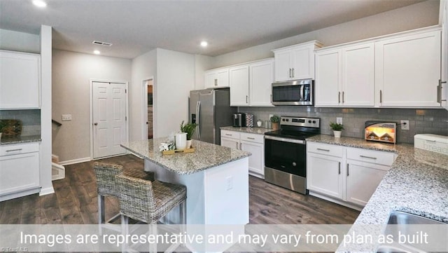 kitchen featuring white cabinetry, dark wood-type flooring, stainless steel appliances, and light stone counters