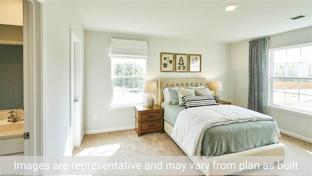 carpeted bedroom featuring sink