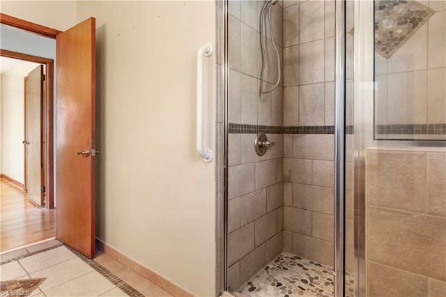 bathroom featuring walk in shower and hardwood / wood-style flooring