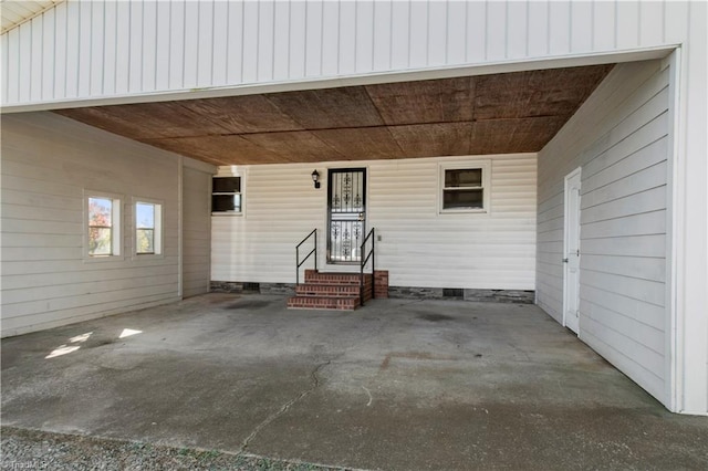 view of exterior entry with a carport