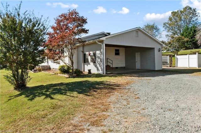 view of front facade with a front yard and a carport