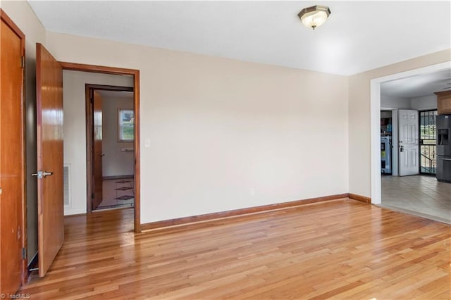 spare room with light hardwood / wood-style flooring and a wealth of natural light