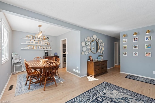 dining area with light hardwood / wood-style floors