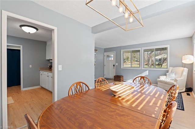 dining space featuring light wood-type flooring