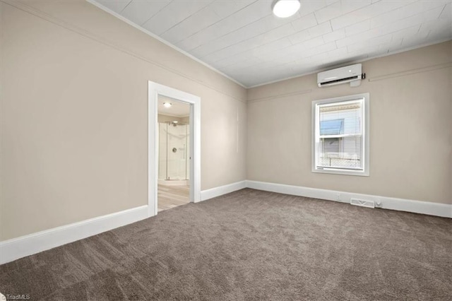 empty room with a wall unit AC, carpet floors, visible vents, baseboards, and crown molding