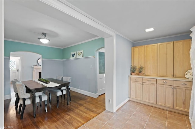 tiled dining area featuring ornamental molding