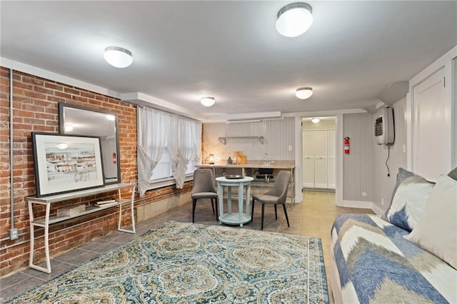 living room featuring brick wall