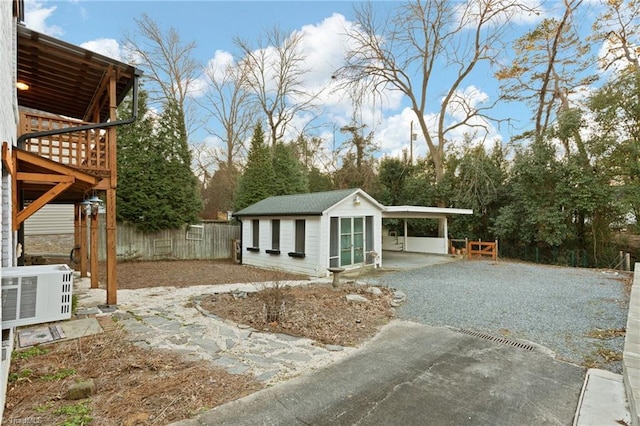 view of yard featuring a carport, an outbuilding, and central AC