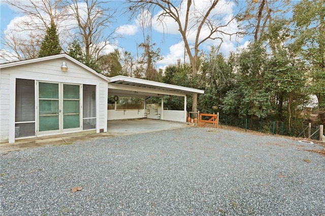 view of side of property featuring a carport