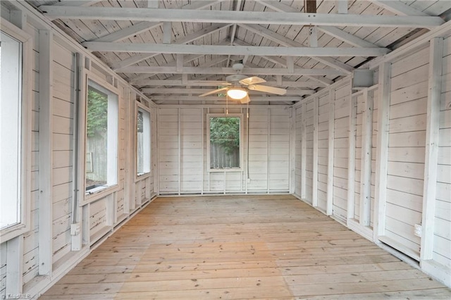 unfurnished sunroom featuring vaulted ceiling with beams, ceiling fan, and wooden ceiling