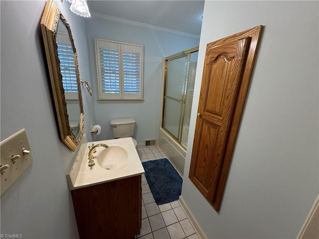 full bathroom featuring bath / shower combo with glass door, vanity, toilet, crown molding, and tile patterned floors