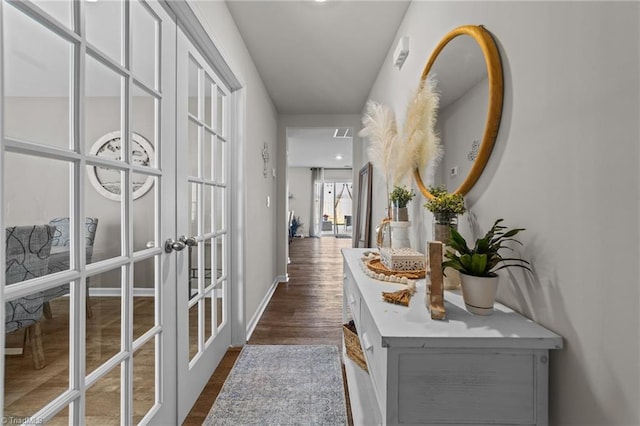 hall featuring french doors, dark wood-style flooring, and baseboards