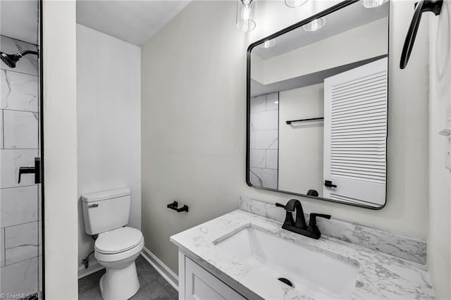 bathroom with tile patterned floors, vanity, and toilet